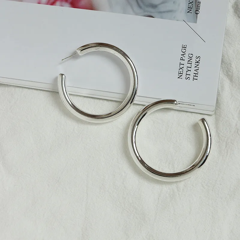 Golden Geometric C-Shaped Earrings with Global Appeal